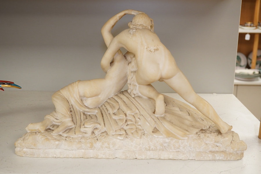 An alabaster figural carving of Cupid and Psyche, 28cm high, 45cm wide. Condition - poor to fair, some damage particularly to her hand, Cupid’s wings missing, etc.